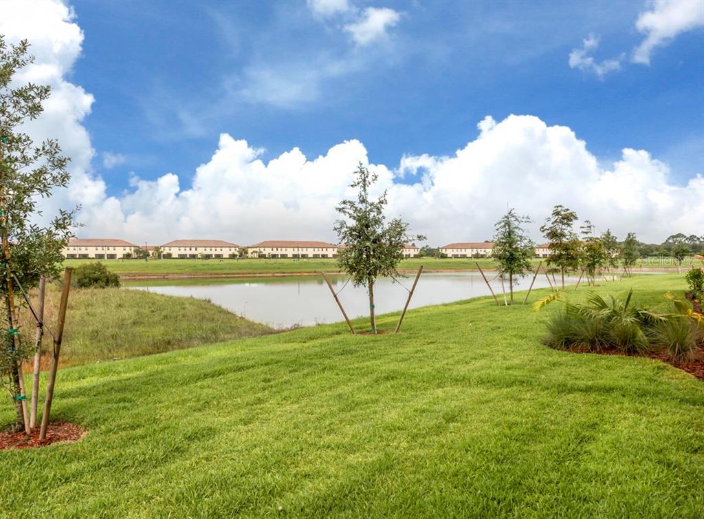 12550 Ghiberti Circle, Unit 201 Venice, FL 34293 - Photo 26 of 44 a view of a lake with a big yard