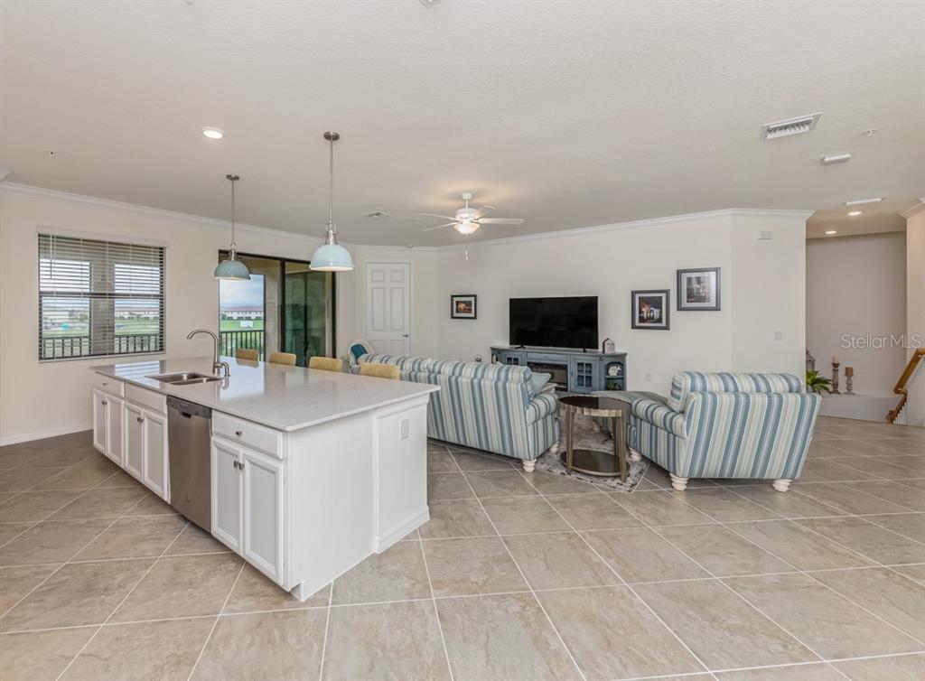 12550 Ghiberti Circle, Unit 201 Venice, FL 34293 - Photo 3 of 44 a large white kitchen with a large window