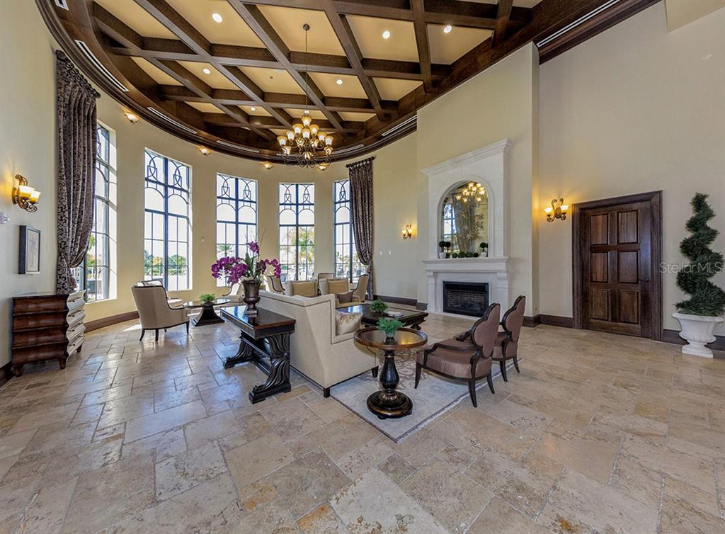 12550 Ghiberti Circle, Unit 201 Venice, FL 34293 - Photo 35 of 44 a living room with furniture and a fireplace