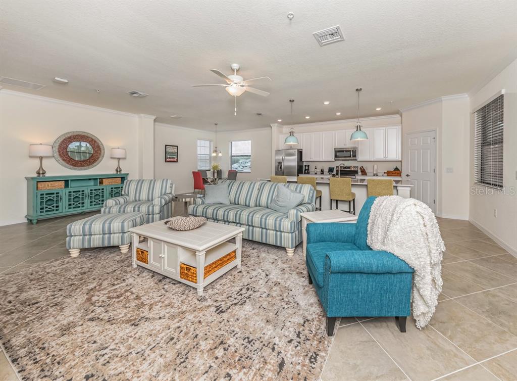 12550 Ghiberti Circle, Unit 201 Venice, FL 34293 - Photo 10 of 44 a living room with furniture and a table