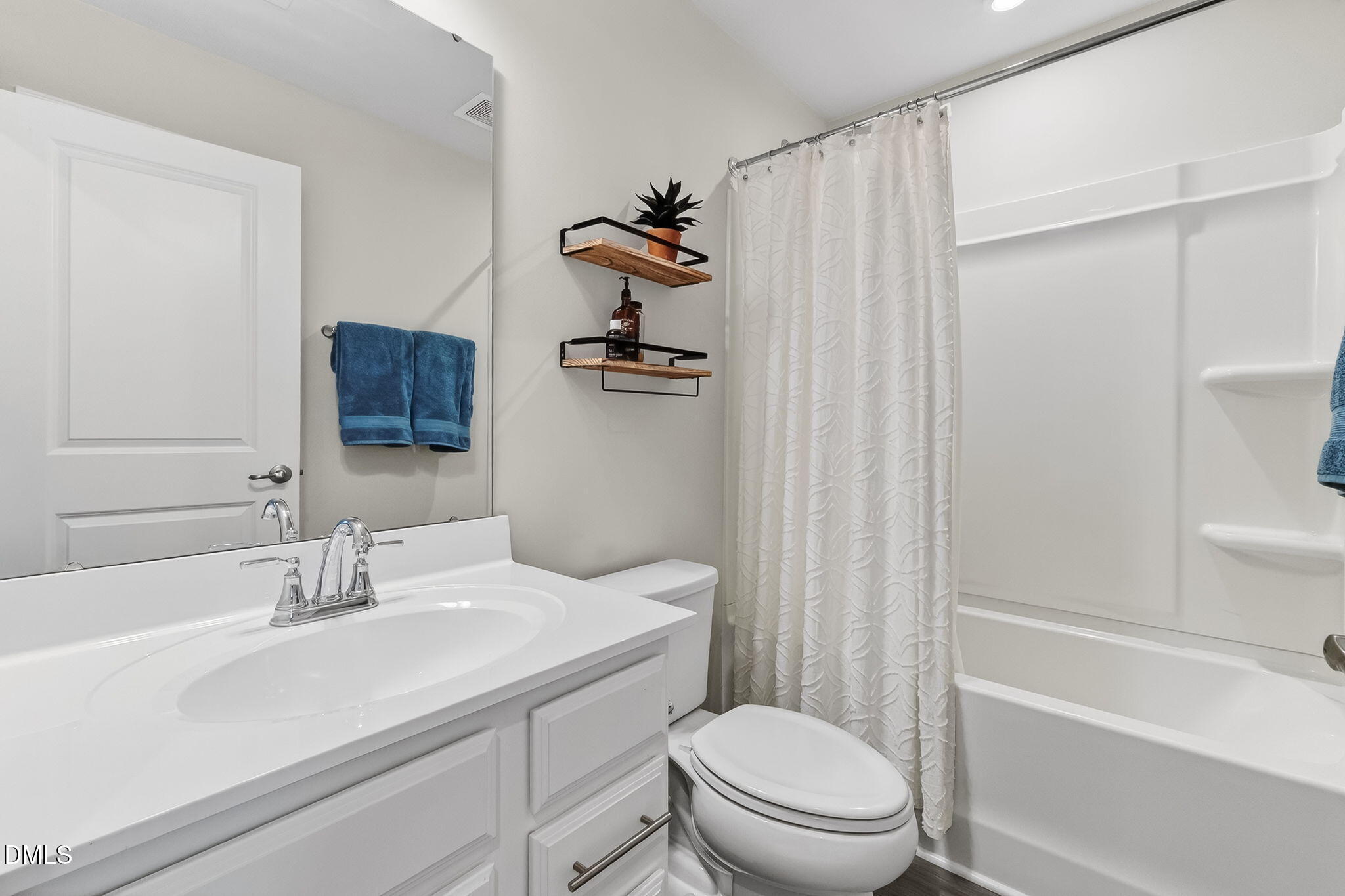 4922 Crossley Street Raleigh, NC 27616 - Photo 19 of 28 a bathroom with a sink a toilet and shower