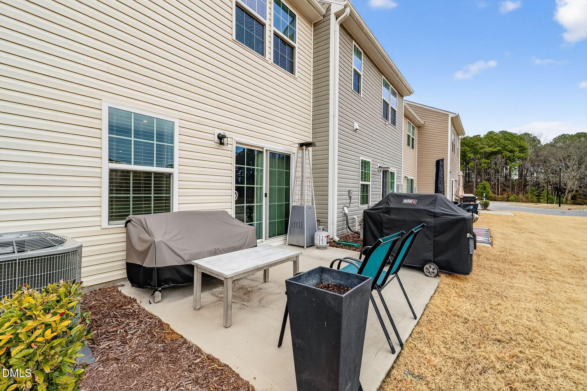4922 Crossley Street Raleigh, NC 27616 - Photo 21 of 28 a view of a patio with a table and chairs and a barbeque