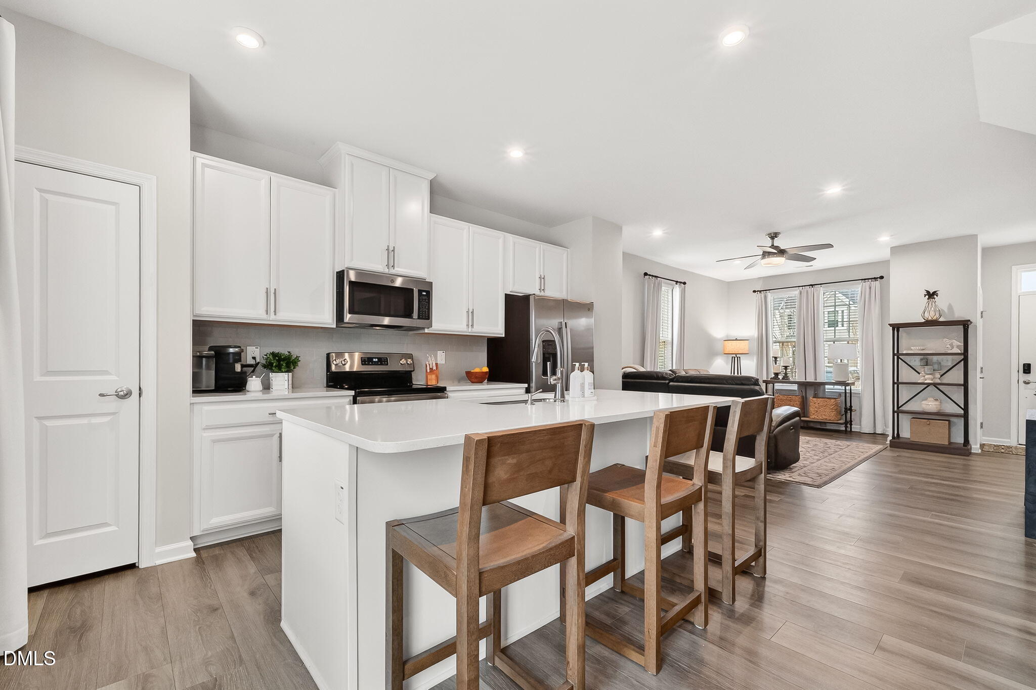 4922 Crossley Street Raleigh, NC 27616 - Photo 9 of 28 a kitchen with white cabinets and stainless steel appliances