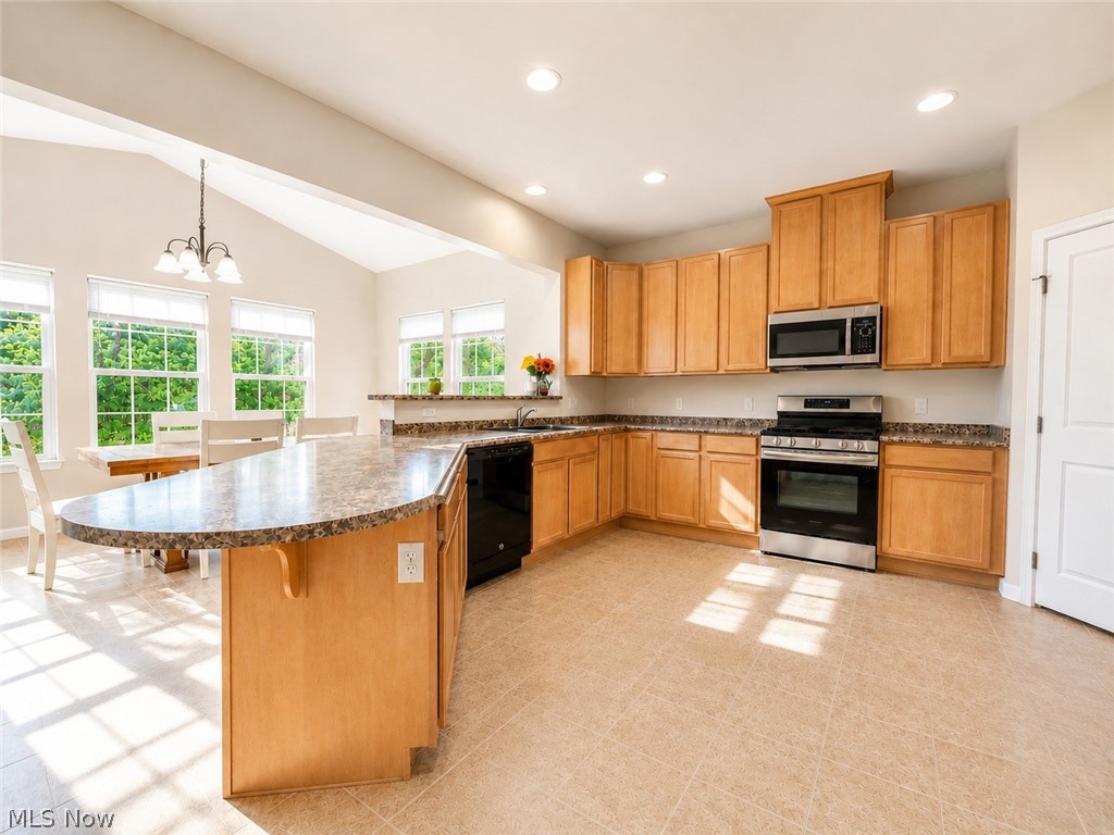 867 Starr Ridge Street Southeast Massillon, OH 44646 - Photo 7 of 29 Kitchen featuring light wood cabinetry, stone-finish countertops, stainless steel appliances, and tile flooring