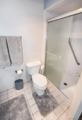 a bathroom with a toilet and a shower