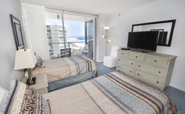 a bedroom with a bed and flat screen tv