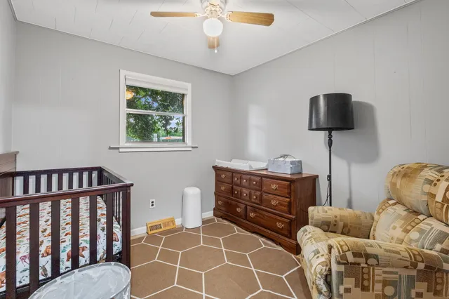 a bedroom with furniture and a window
