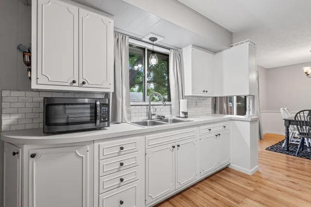 a kitchen with cabinets appliances and a window