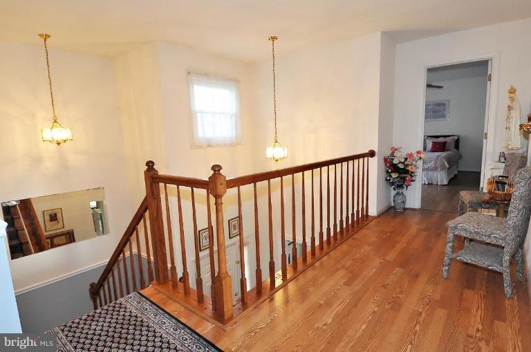 4107 Ulster Road Beltsville, MD 20705 - Photo 11 of 21 a view of a hallway with wooden floor and stairs