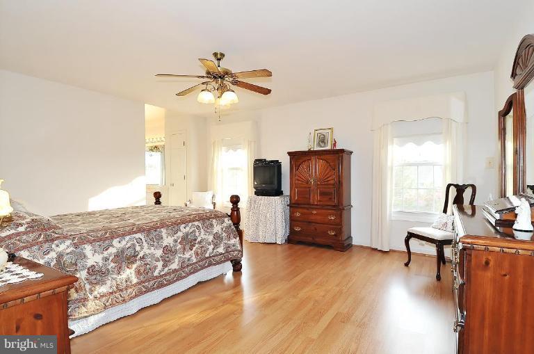 4107 Ulster Road Beltsville, MD 20705 - Photo 12 of 21 a bedroom with a bed and wooden floor