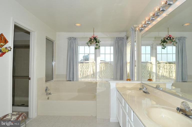 4107 Ulster Road Beltsville, MD 20705 - Photo 13 of 21 a spacious bathroom with a tub sink and mirror