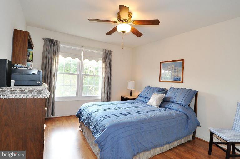 4107 Ulster Road Beltsville, MD 20705 - Photo 16 of 21 a bedroom with a large bed and a chandelier