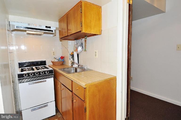 4107 Ulster Road Beltsville, MD 20705 - Photo 20 of 21 a kitchen that has a sink and a stove
