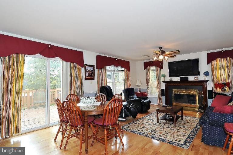 4107 Ulster Road Beltsville, MD 20705 - Photo 9 of 21 a living room with fireplace furniture and a flat screen tv