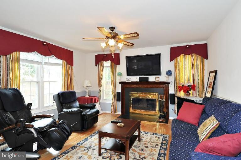 4107 Ulster Road Beltsville, MD 20705 - Photo 10 of 21 a living room with furniture a fireplace and a flat screen tv