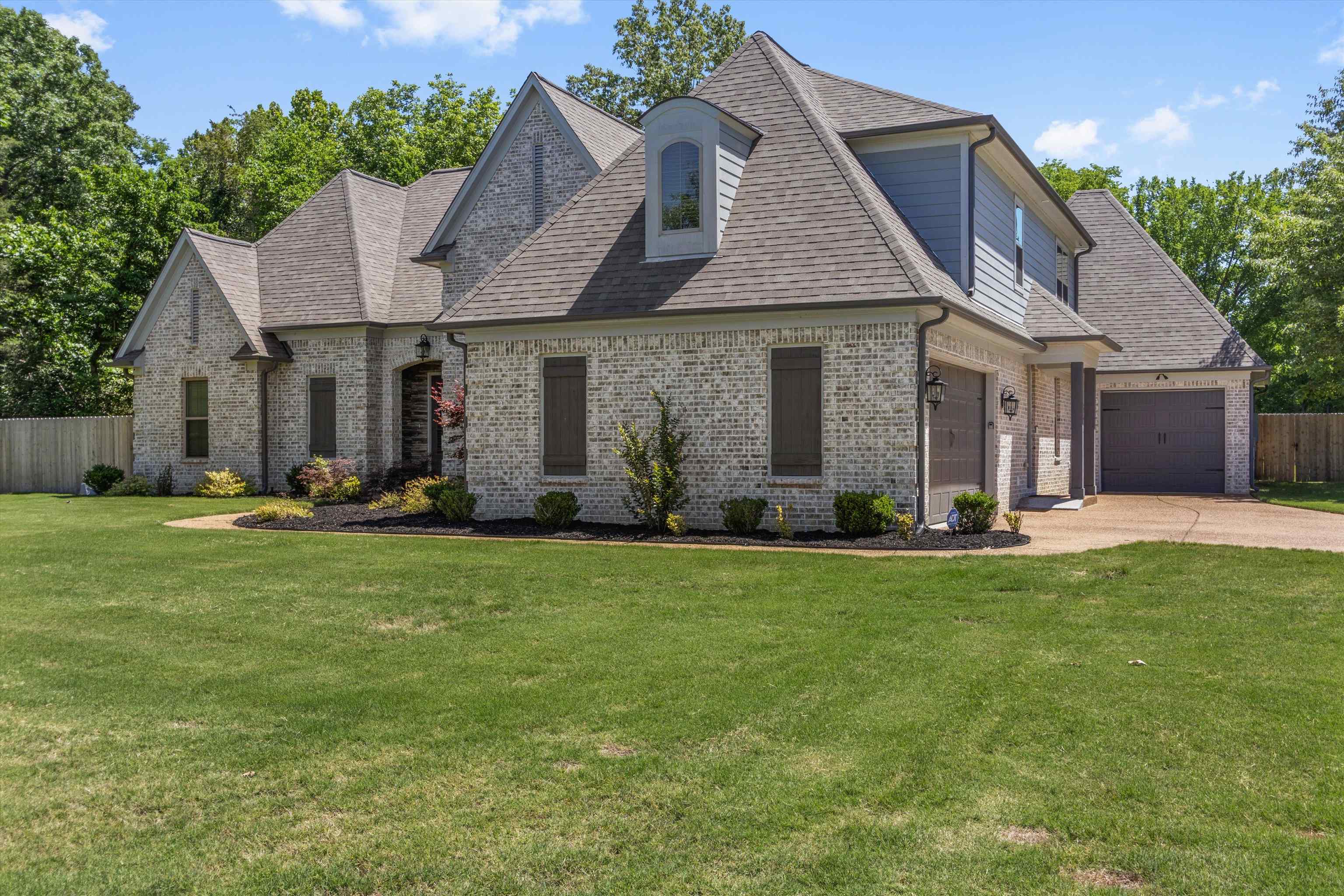 65 Watson Road Oakland, TN 38060 - Photo 2 of 40 a front view of a house with a yard