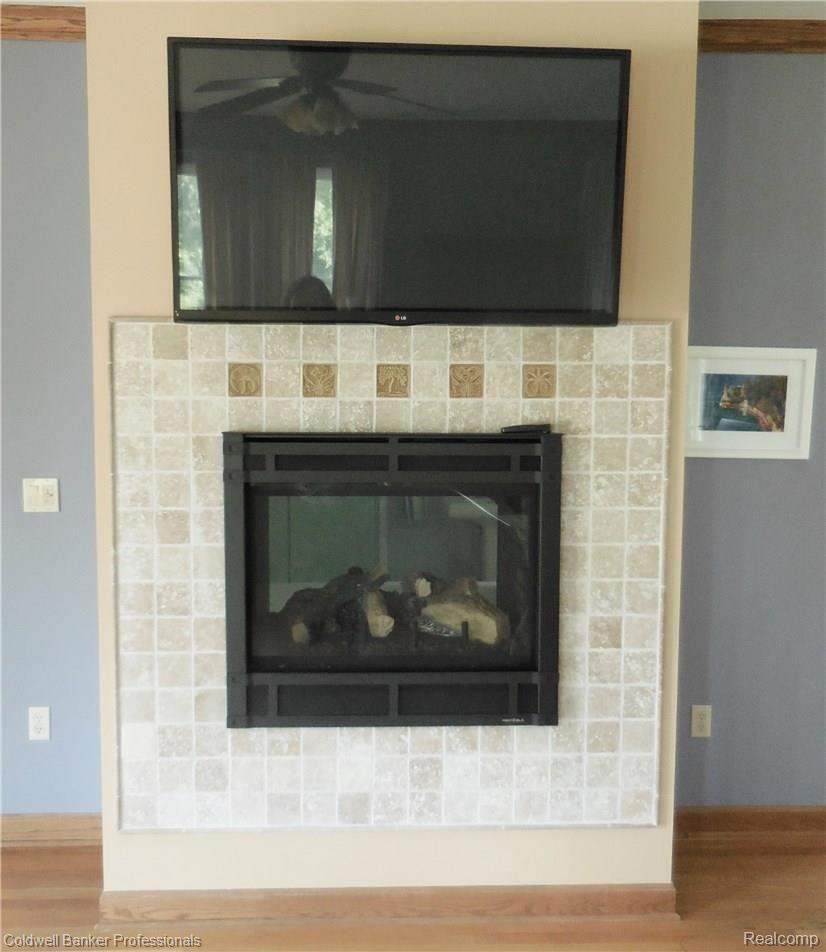 21591 Garfield Road Northville, MI 48167 - Photo 39 of 90 TWO-WAY, GAS FIREPLACE WITH CUSTOM TILE WORK