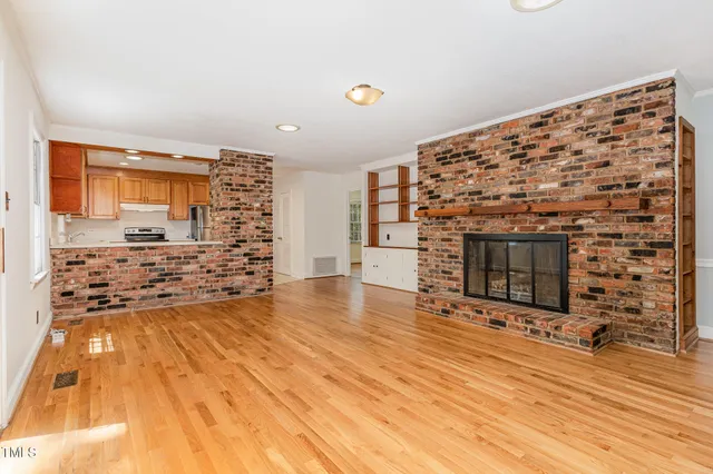 a living room with a fireplace and a flat screen tv
