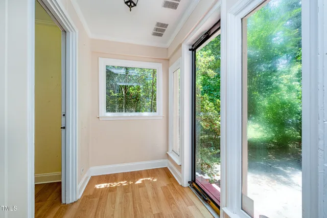a view of empty room with wooden floor and outdoor view
