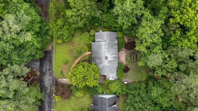an aerial view of a house with outdoor space and street view
