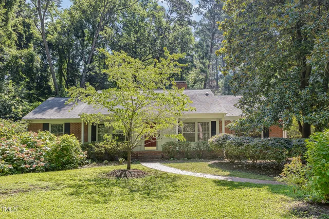 a house that has a tree in front of it