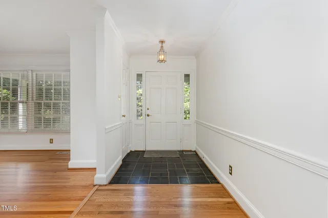 a view of a hallway view with wooden floor and staircase