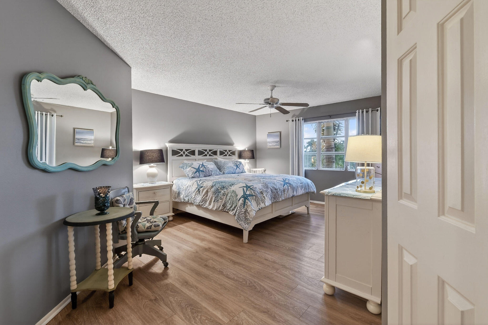 170 Seabreeze Circle Jupiter, FL 33477 - Photo 32 of 72 a bedroom with a bed window and a mirror