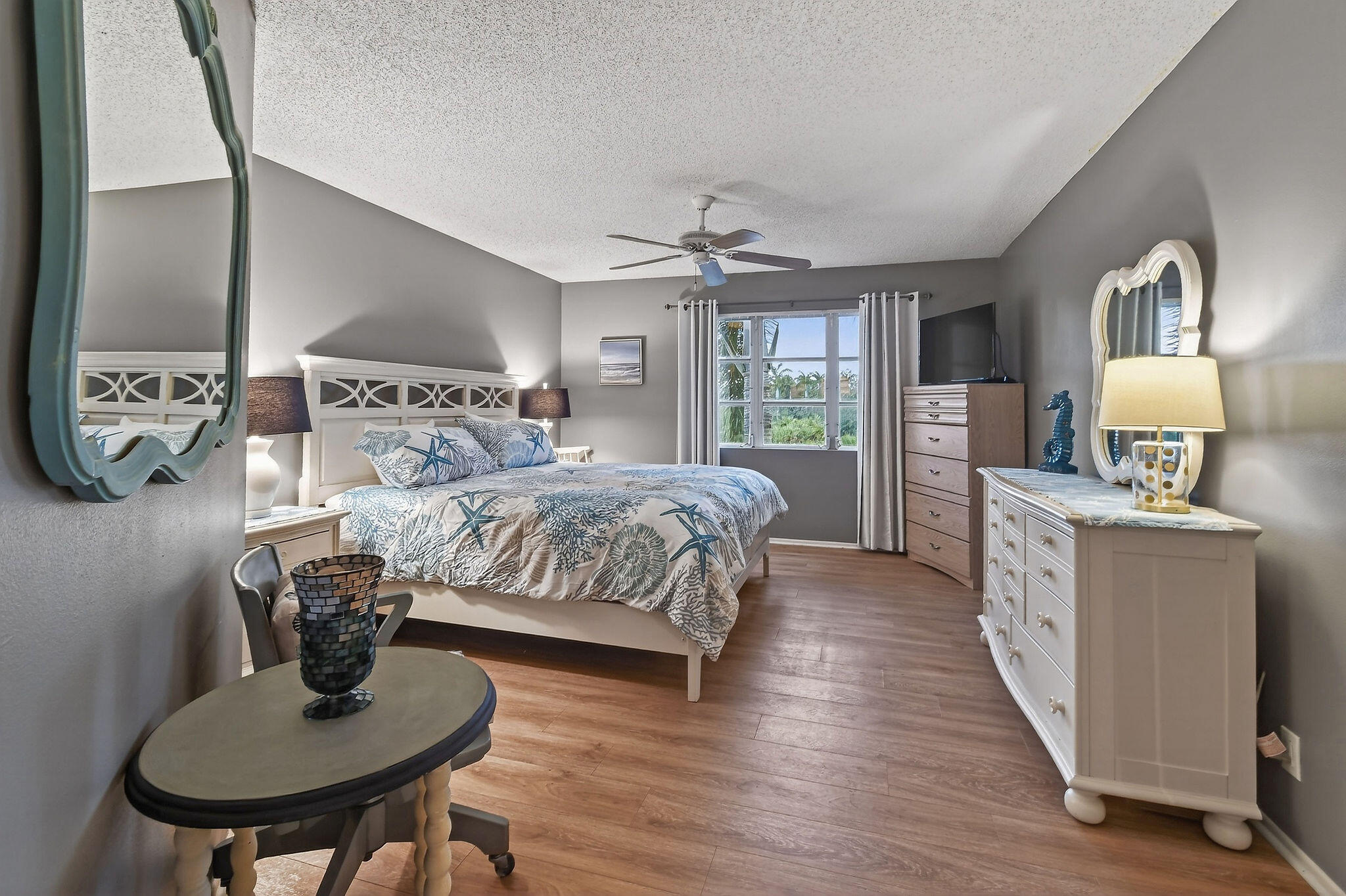 170 Seabreeze Circle Jupiter, FL 33477 - Photo 34 of 72 a bedroom with a bed and dresser with mirror