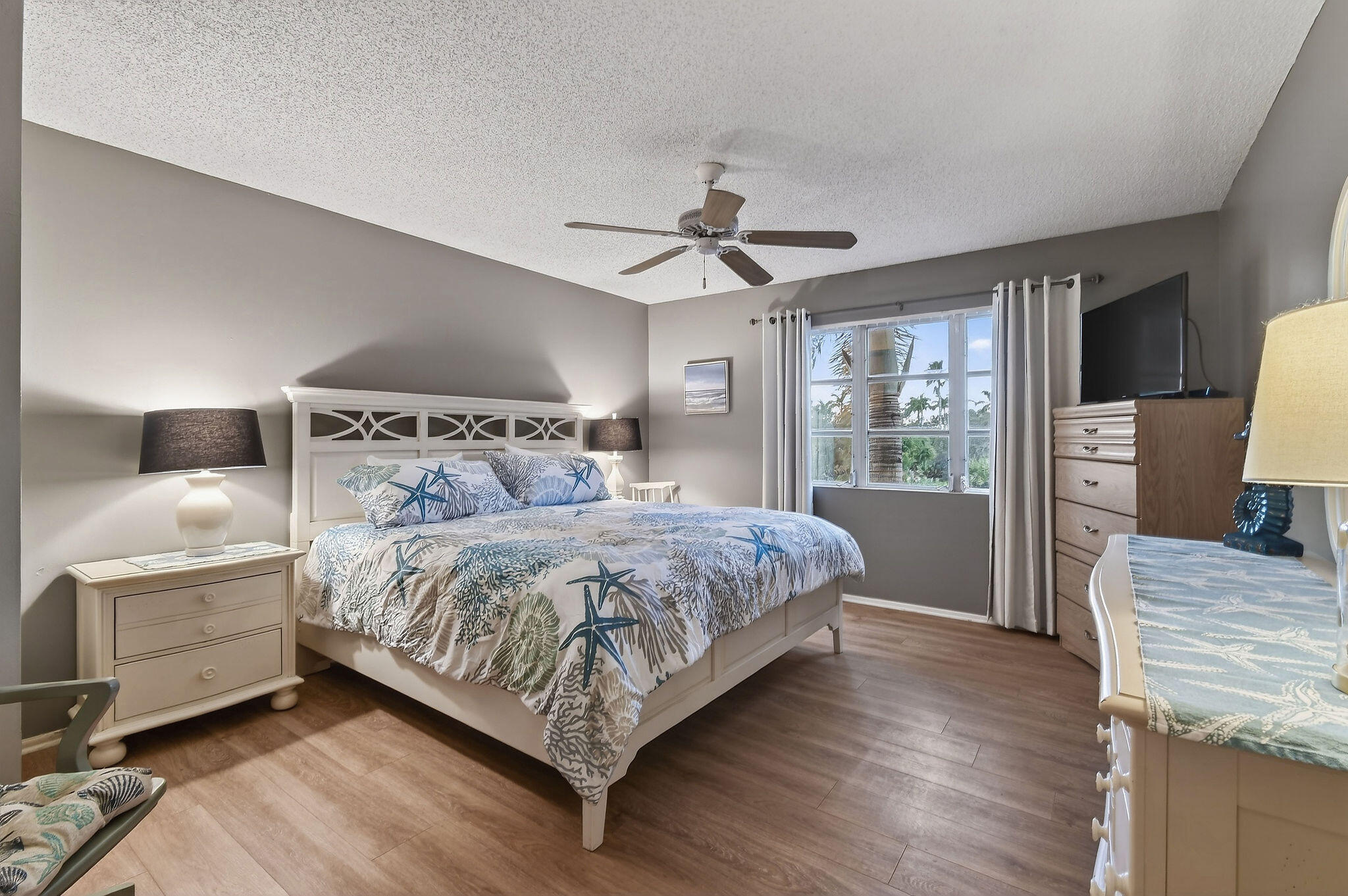 170 Seabreeze Circle Jupiter, FL 33477 - Photo 35 of 72 a bedroom with a bed chandelier and a window