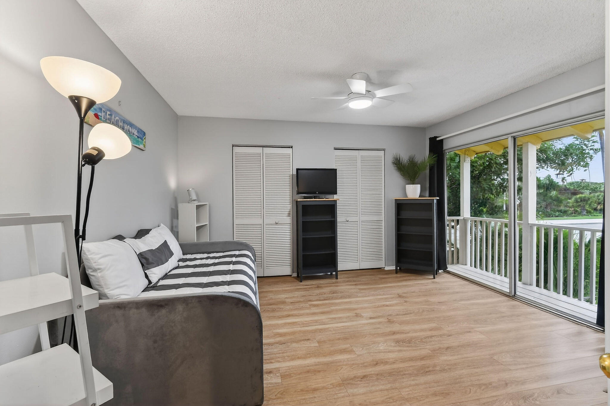 170 Seabreeze Circle Jupiter, FL 33477 - Photo 47 of 72 a bedroom with a bed and a chandelier