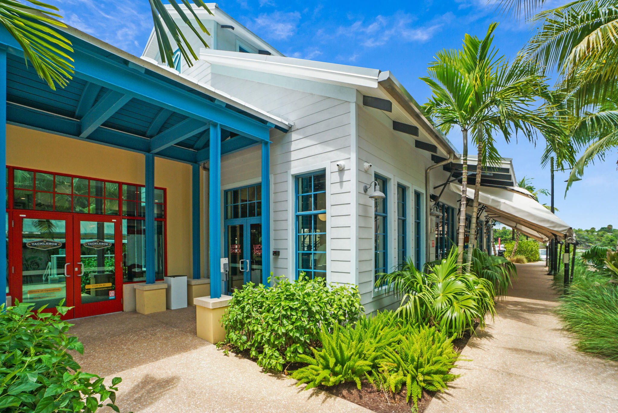 170 Seabreeze Circle Jupiter, FL 33477 - Photo 67 of 72 a view of a house with potted plants and a flower garden