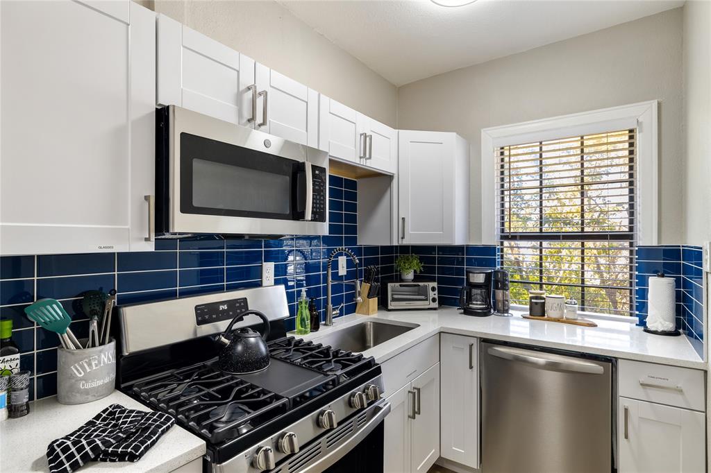4400 Gaston Avenue, Unit 3 Dallas, TX 75246 - Photo 1 of 10 a kitchen with a stove a sink and a microwave