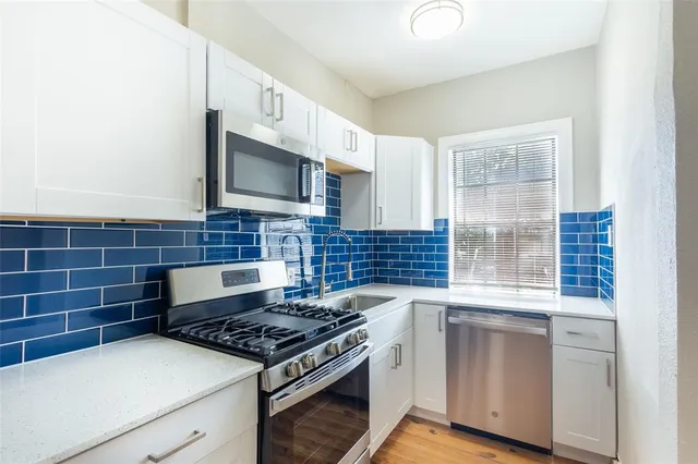 a kitchen with cabinets and appliances