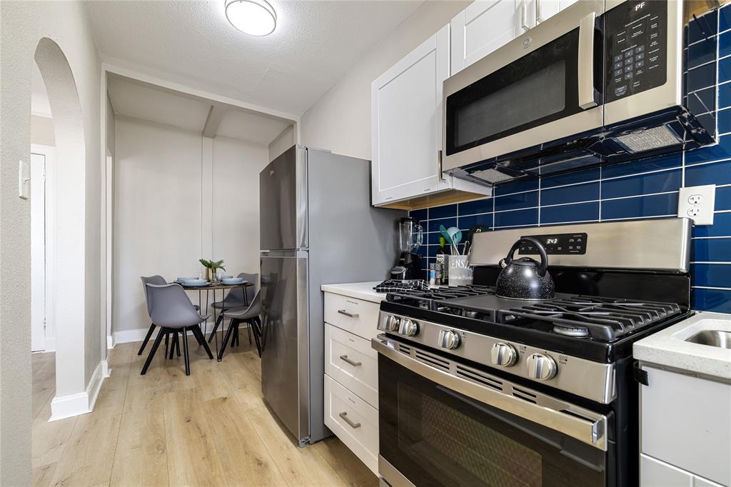 4400 Gaston Avenue, Unit 3 Dallas, TX 75246 - Photo 2 of 10 a kitchen with a stove and a microwave