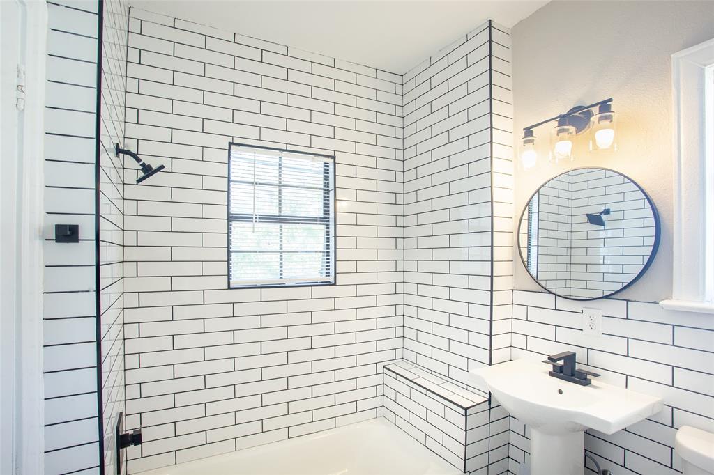4400 Gaston Avenue, Unit 3 Dallas, TX 75246 - Photo 3 of 6 a bathroom with a sink a mirror and a shower