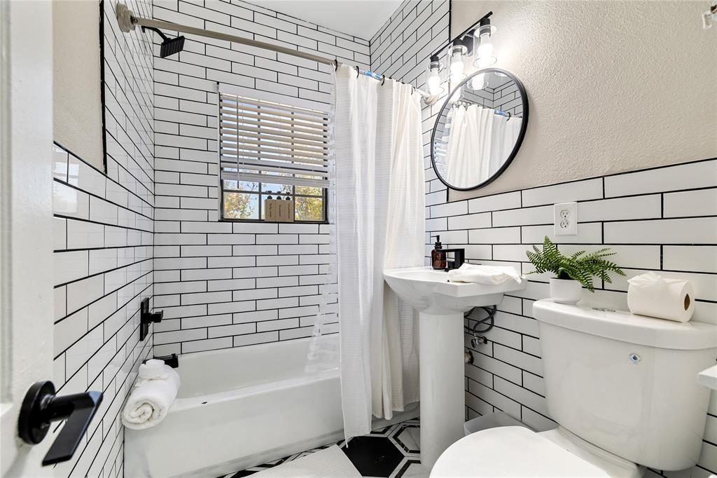 4400 Gaston Avenue, Unit 3 Dallas, TX 75246 - Photo 7 of 10 a bathroom with a sink a toilet and shower
