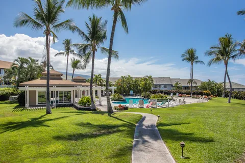 a view of a house with a swimming pool and a big yard