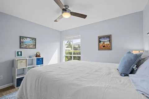 a bedroom with a large bed and a chandelier