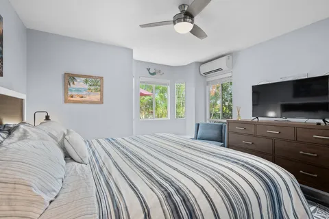 a bedroom with a large bed and a flat screen tv