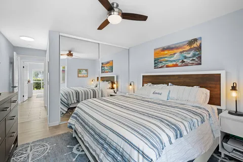 a bedroom with a bed and a painting on the wall
