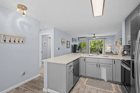 a kitchen with a sink stove and refrigerator