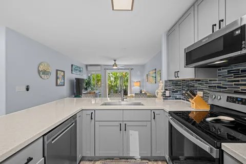 a kitchen with a sink stove and cabinets