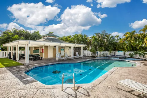 a view of a house with swimming pool and sitting area