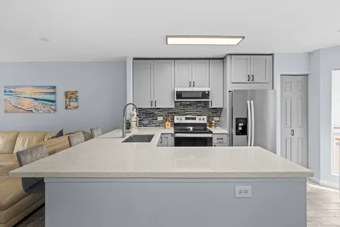a kitchen with a appliances a sink and a refrigerator