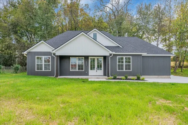 a front view of a house with a garden and yard