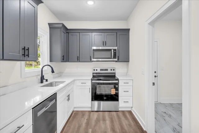 a kitchen with a sink stove and cabinets