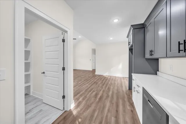 wooden floor in an empty room and a kitchen