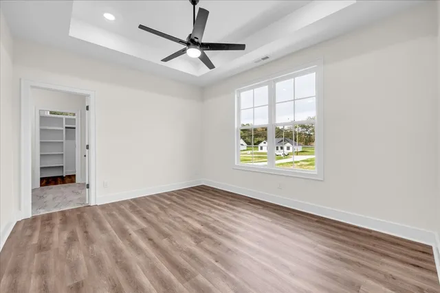 wooden floor in an empty room with a window