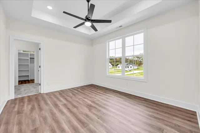wooden floor in an empty room with a window