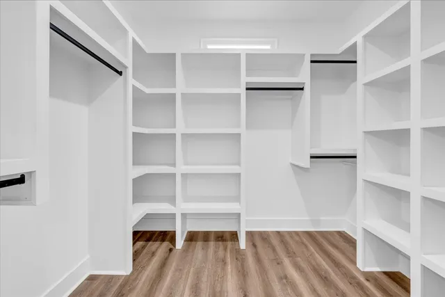 a view of walk in closet with empty racks